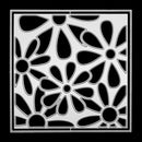 A square metal stencil with a black and silver floral pattern, shown flat against a solid black background.