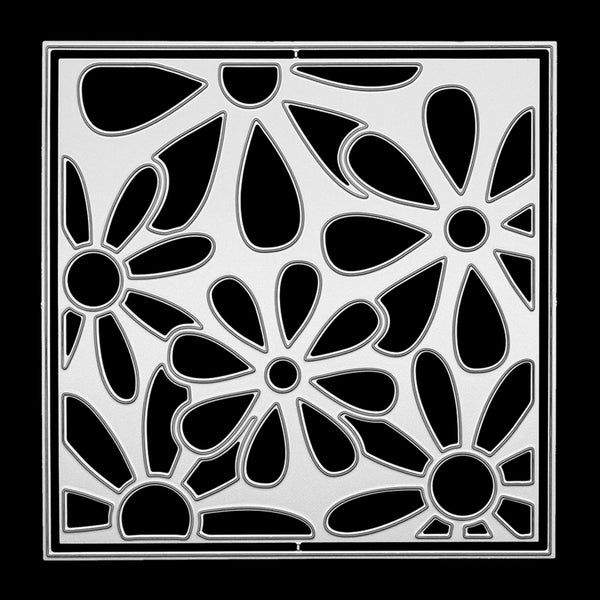 A square metal stencil with a black and silver floral pattern, shown flat against a solid black background.