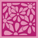 A square pink stencil or decorative cutout sheet with a repeating floral pattern, shown against a solid pink background.
