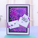 A handmade layered greeting card or gift card with a purple glitter heart background, two white envelopes, and the phrase 'You make me happy in my heart' printed on one envelope, displayed on a light surface.