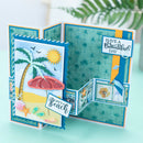 A handmade pop-up beach-themed card displayed open, featuring a palm tree, red beach umbrella, sand, seashells, and decorative text including 'HAVE A Beautiful DAY' and 'LIFE'S A Beach'.