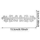 A metal die-cut holiday garland featuring gingerbread men, houses, and Christmas trees, shown with dimension arrows indicating a width of 15.5cm (6.