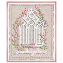 A square handmade card featuring a white arched window design surrounded by pink flowers and green leaves, with the phrase 'sending love' in white script at the bottom. The card has a pink border and is photographed against a plain white background.