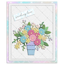 A square handmade-style greeting card featuring a colorful paper flower bouquet in a lavender pot, with a small white tag reading 'sending love' on a pastel patterned border.