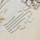 Four silver metal nail hangers with bird-shaped tips, arranged on a textured cream fabric alongside cotton stems and a small wooden tag.