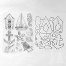 Clear plastic craft stamp set featuring nautical designs including a sailboat, anchor, seahorse, starfish, beach chair, shells, and beach huts, shown with matching metal cutting dies on a white background.