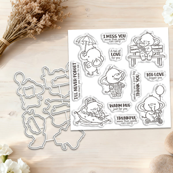 A clear stamp set and matching die cut outlines displayed on a light wood surface with dried flowers and white blossoms. The stamp sheet features cartoon animals and phrases such as 'I MISS YOU', 'BIG LOVE', 'THANK YOU', and 'WARM HUG'.