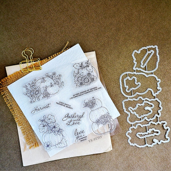 Clear stamp set with autumn-themed designs including pumpkins, flowers, and phrases like 'Harvest' and 'Gathered with Love', shown with metal die-cut outlines on a brown textured background.
