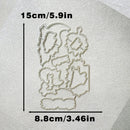 A set of metal die-cut craft templates arranged on a textured off-white surface, with black measurement lines and text showing dimensions of 15cm/5.9in tall and 8.