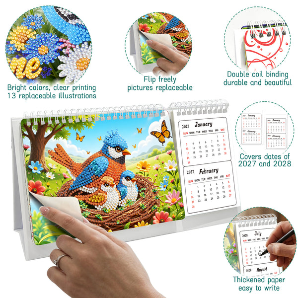 A diamond painting style desktop calendar with a bird-and-floral scene on the front cover, shown on a white background with circular callout insets demonstrating features such as colorful replaceable illustrations, freestyle flipping, double coil binding, date coverage for 2027 and 2028, and thick paper for writing. A human hand is visible peeling back the cover, so this is classified as Lifestyle rather than Product/Packaging.