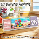Desk calendar with beach-themed design, colorful flip-flops, and diamond painting tools on a table.
