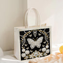 Decorative tote bag with butterfly design on a light background