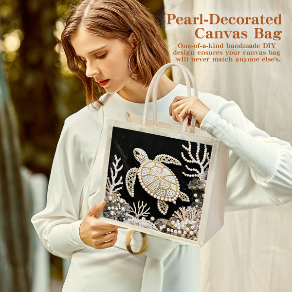Woman holding a pearl-decorated canvas bag with a turtle design.