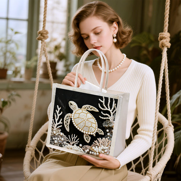 Woman holding a tote bag with a turtle design in a home setting