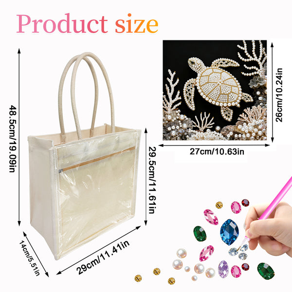 Beige tote bag with clear front pocket, turtle design, and decorative gemstones on a black background.