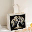 Tote bag with decorative tree design on a black background