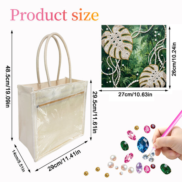 A clear plastic beach tote bag with beige handles, shown with dimension labels on a white background. An inset shows a green tropical monstera leaf pattern with rhinestones and pearls, and a hand is shown applying colorful rhinestones.