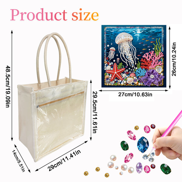 Product size diagram showing a clear plastic tote bag with cream handles, labeled dimensions of 48.5cm x 29cm x 14cm, alongside a small underwater-themed patch or sticker sheet and a hand placing colorful rhinestones.