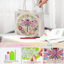 A clear canvas tote bag decorated with a colorful embroidered dragonfly and surrounded by faux pearls, shown with a hand placing a white item into its handle. The image includes text overlays describing the product and three small detail panels at the bottom showing dotting accessories, pearl diamonds, and a close-up of the dragonfly design.