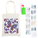 An off-white canvas tote bag with a colorful butterfly and floral print, shown alongside diamond painting tools and small packets of embellishments on a white background.