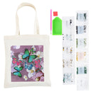 A diamond painting canvas tote bag featuring a purple background with colorful embroidered-style butterflies and white flowers, shown alongside included accessories: a green paint palette, a pink-and-green brush, and multiple rows of labeled bead packets.