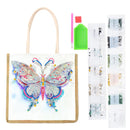 Diamond painting kit featuring a canvas tote bag with a colorful butterfly design, a green paint brush, a pink paint stick, and multiple sheets of small decorative beads.