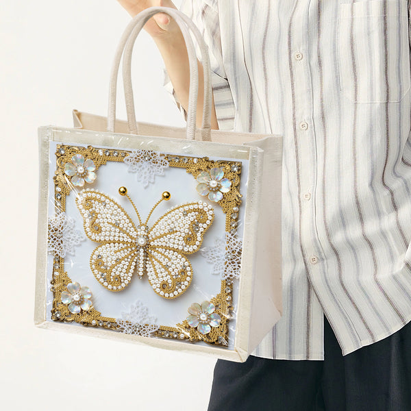 Tote bag with decorative butterfly design held by a person wearing a striped shirt.