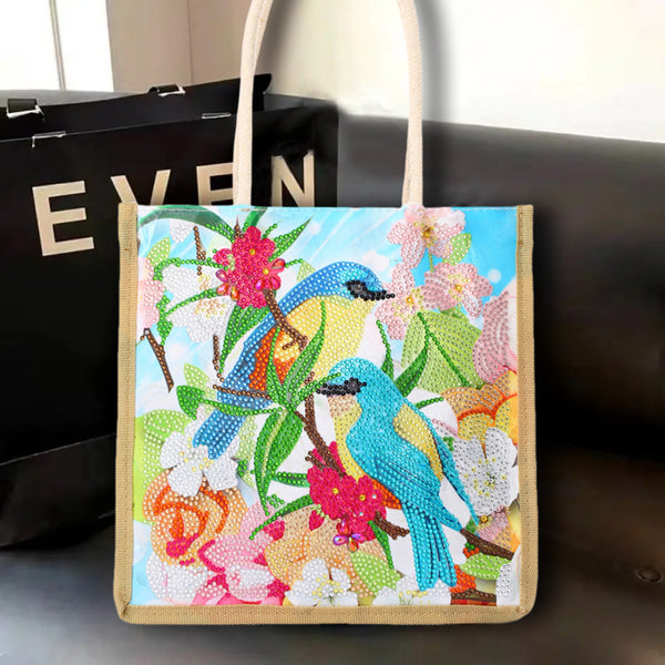 Tote bag with bird and floral design on a dark surface