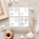 Set of floral stencils on a textured surface with decorative items.