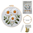 Embroidery DIY art kit with floral design, hoop, needles, and thread on a white background