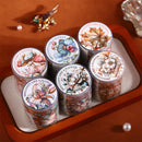 Six rolls of decorative washi tape featuring floral and butterfly illustrations, arranged in a wooden tray with a white lining. The rolls are labeled 'BRILLIANT LIKE A FLOWER' and 'New Year 2024'.