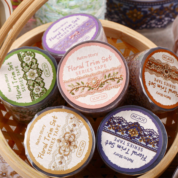Collection of floral trim sets in small containers with decorative labels on a wooden surface.