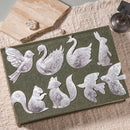 Set of embossed metal animal shapes on a green card with a textured surface.
