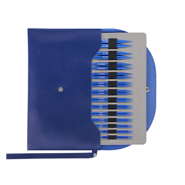 A blue leatherette needle case shown open, revealing a gray insert holding multiple blue and black needle tips arranged in rows. The case has a snap button closure and a wrist strap, photographed on a plain white background.