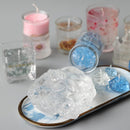 Crystal-like rocks on a tray with candles in the background