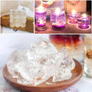 Collage of clear gelatinous blocks on a wooden plate with lit candles in the background.
