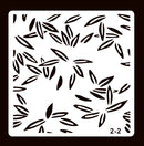 A square stencil template with a repeating pattern of black leaf-like cutouts on a white sheet, shown against a dark brown background. The number '2-2' is printed in the bottom right corner.