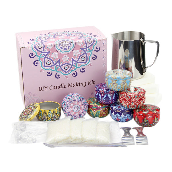 DIY Candle Making Kit with a pink mandala-patterned box, a stainless steel pitcher, colorful patterned wax containers, wicks, wick stands, and wax packets on a white background.