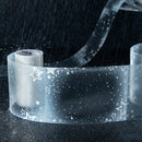Roll of transparent tape with star pattern on a dark background