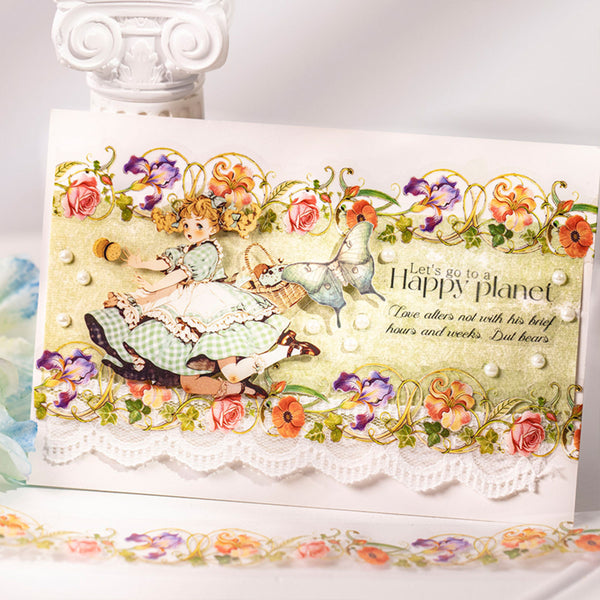 A handmade vintage-style greeting card featuring an illustration of a young girl in a green-and-white dress beside a white rabbit, surrounded by colorful flowers and gold decorative flourishes. The card reads, 'Let's go to a Happy planet' with smaller script text below.