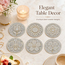 Six round pearl-embellished table coasters arranged on a light marble surface with decorative props including a candle, flowers, pearls, and a slice of cake. Text reads 'Elegant Table Decor' and '6 unique pearl coaster designs'.