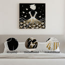 Decorative wall art of a woman in a dress with butterflies, displayed on a wall above a sofa.