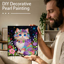 Man holding a completed DIY decorative pearl painting of a colorful cat.