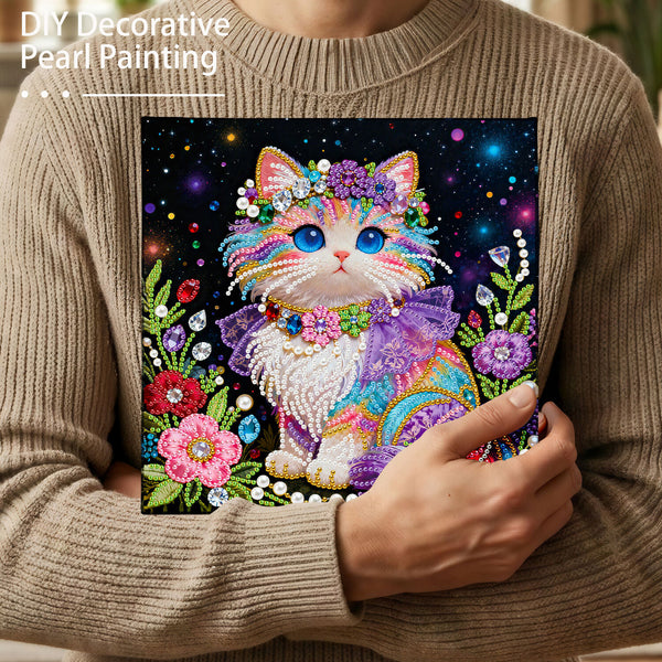 Person holding a colorful cat painting made with decorative pearls.