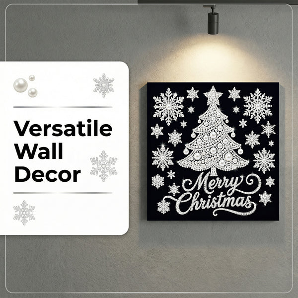 A square black Christmas wall art piece with a white tree, snowflakes, and 'Merry Christmas' script, mounted on a gray wall under a spotlight. A white label on the left reads 'Versatile Wall Decor' with snowflake graphics.