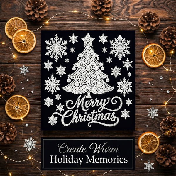 A square black Christmas art print featuring a white lace-style tree, snowflakes, and the words 'Merry Christmas,' styled on a dark wood surface with dried orange slices, pinecones, and warm fairy lights. A banner at the bottom reads 'Create Warm Holiday Memories.