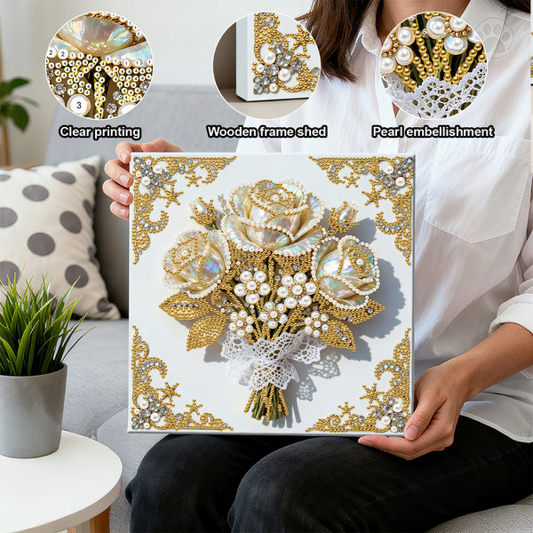 Person holding a decorative painting with floral design, pearl embellishments, and wooden frame.