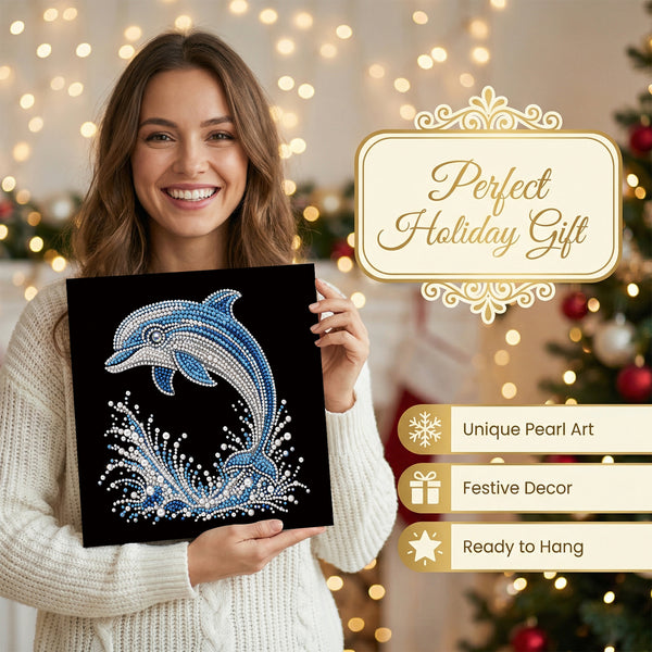 A woman in a white knit sweater holds a black diamond painting canvas featuring a blue and silver dolphin design. The background is a festive Christmas tree with warm string lights, and promotional text on the right reads 'Perfect Holiday Gift' with features like 'Unique Pearl Art', 'Festive Decor', and 'Ready to Hang'.