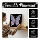 A woman in a patterned sweater hangs a square black canvas featuring a colorful butterfly design on a wooden shelf in a home setting. The image includes marketing text reading 'Versatile Placement' and feature icons stating 'Fits Small Spaces,' 'Easy to Place,' and 'Festive Decor Enhancer.