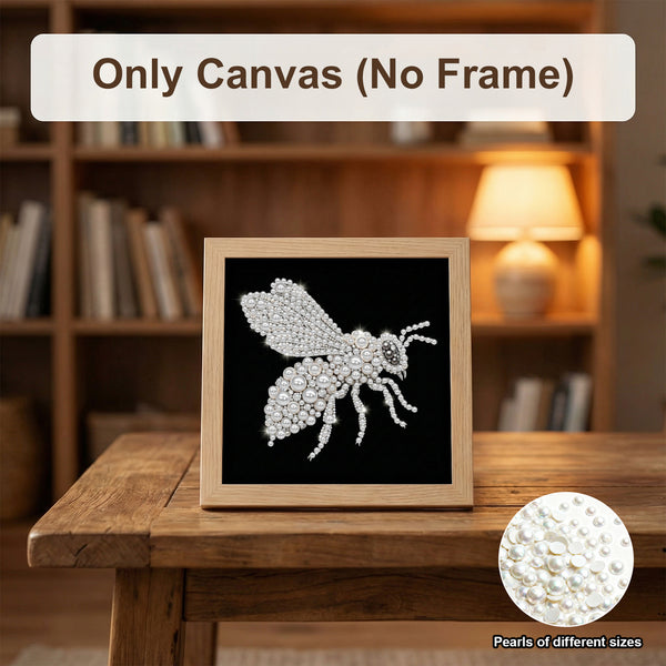 A framed canvas art piece featuring a sparkling silver beehive design on a black background, displayed on a wooden table in a warm, blurred library setting. Text overlays read 'Only Canvas (No Frame)' and 'Pearls of different sizes' with a circular inset showing the pearl texture.